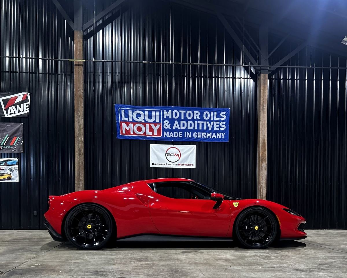Ferrari under the Bluegrass Precision Motorwerks sign