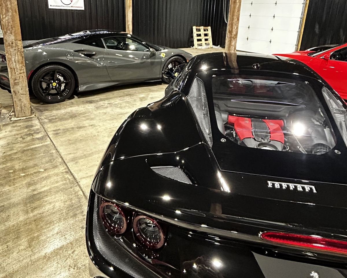Black Ferrari with the engine on display at Bluegrass Precision Motorwerks