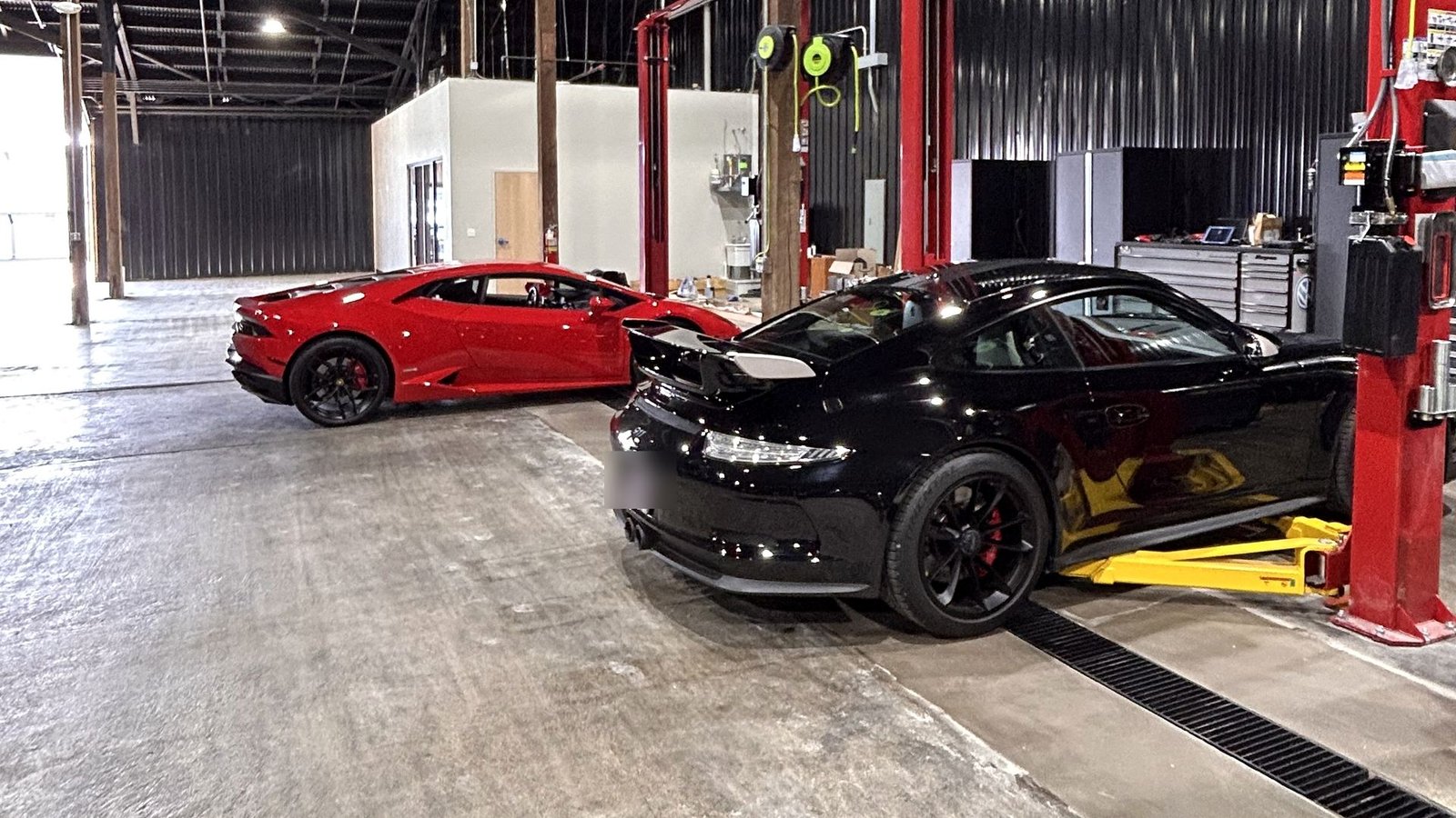 Lamborghini and Porsche in the service bays at Bluegrass Precision Motorwerks