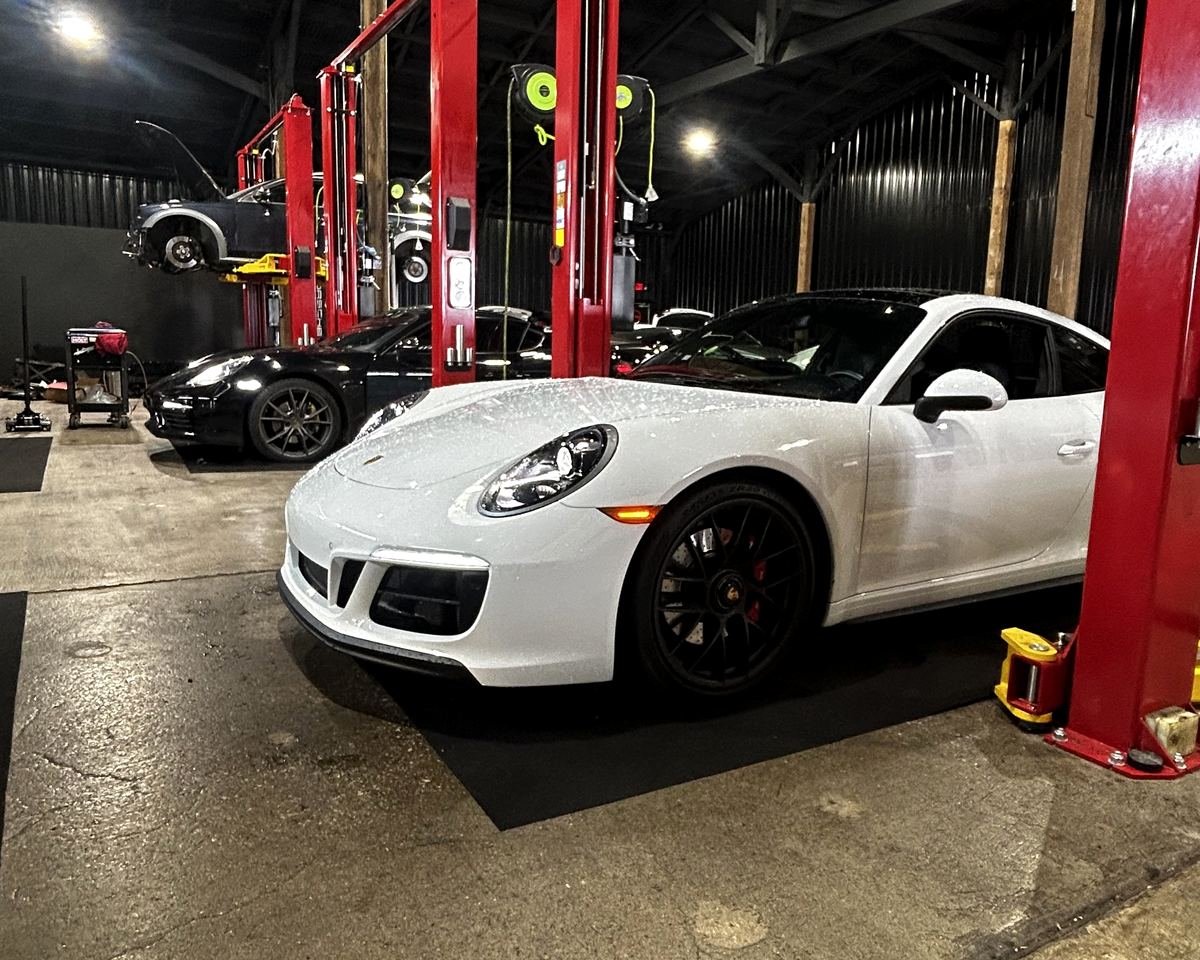 White Porsche 911 in the service bay at Bluegrass Precision Motorwerks